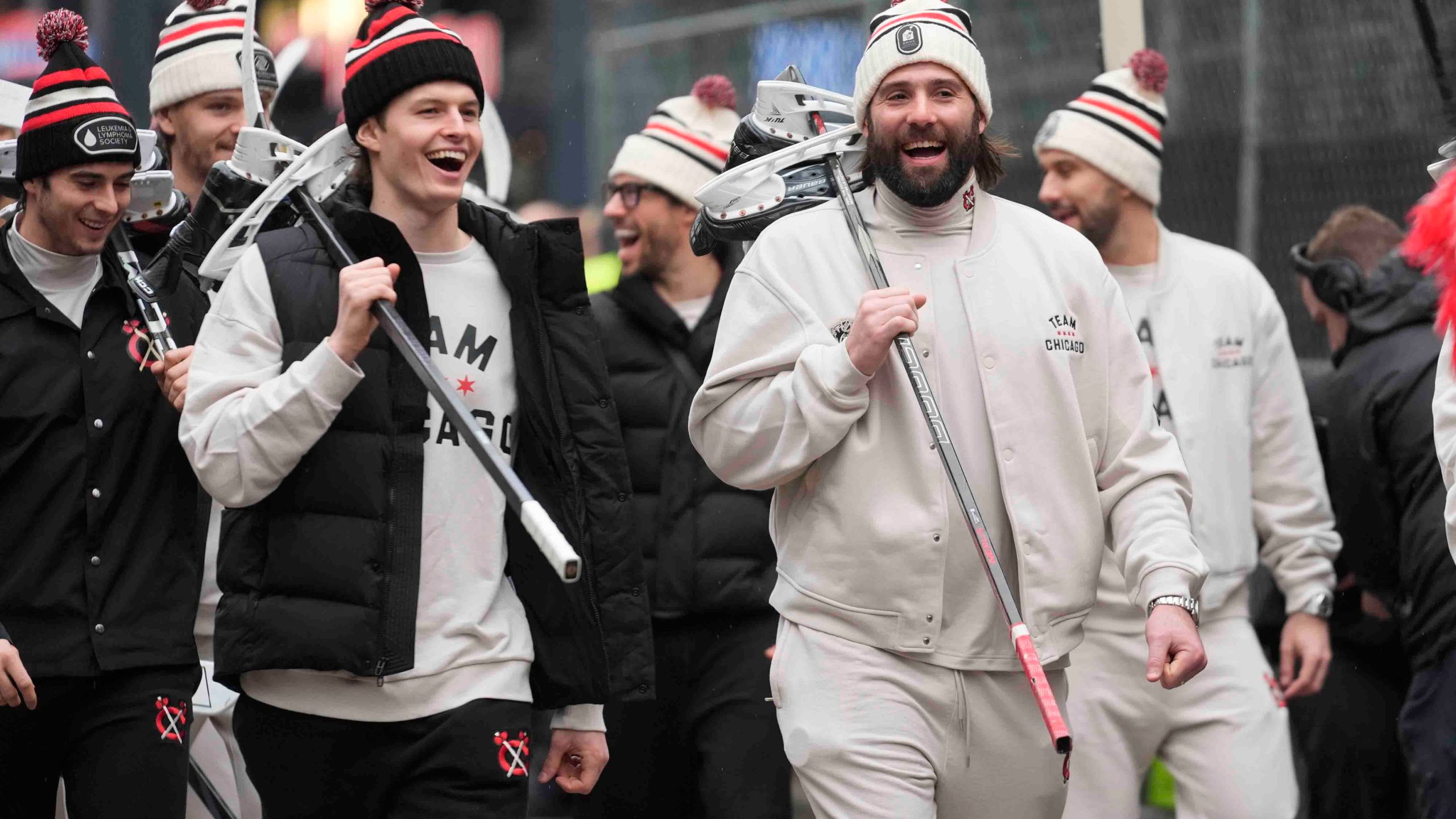 Chicago Blackhawks left wing Lukas Reichel, left, and left wing Patrick Maroon arrive with the team for the NHL Winter Classic outdoor hockey game featuring the Blackhawks and St. Louis Blues at Wrigley Field, Tuesday, Dec. 31, 2024, in Chicago. (AP Photo/Erin Hooley)