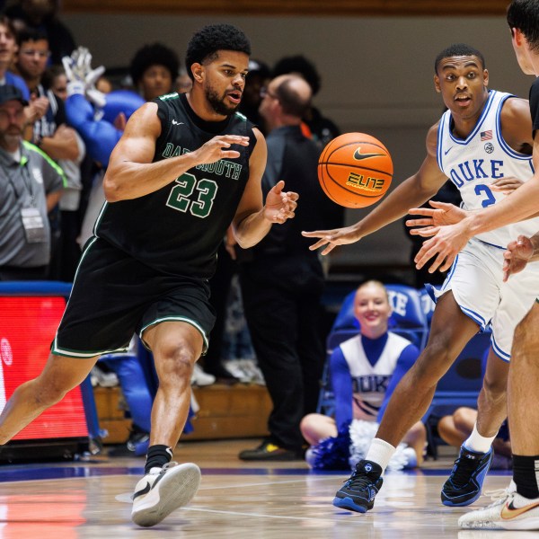 FILE - Dartmouth's Robert McRae III (23) takes a pass from Jackson Munro (33) as Duke's Jaylen Blakes (2) defends during the second half of an NCAA college basketball game in Durham, N.C., Monday, Nov. 6, 2023. (AP Photo/Ben McKeown, File)