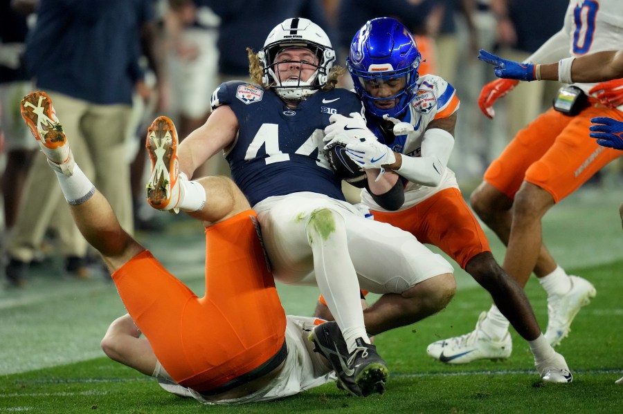 Penn State tight end Tyler Warren (44) is tackled by Boise State defensive end Max Stege (95) during the first half of the Fiesta Bowl NCAA college football CFP quarterfinal game, Tuesday, Dec. 31, 2024, in Glendale, Ariz. (AP Photo/Ross D. Franklin)