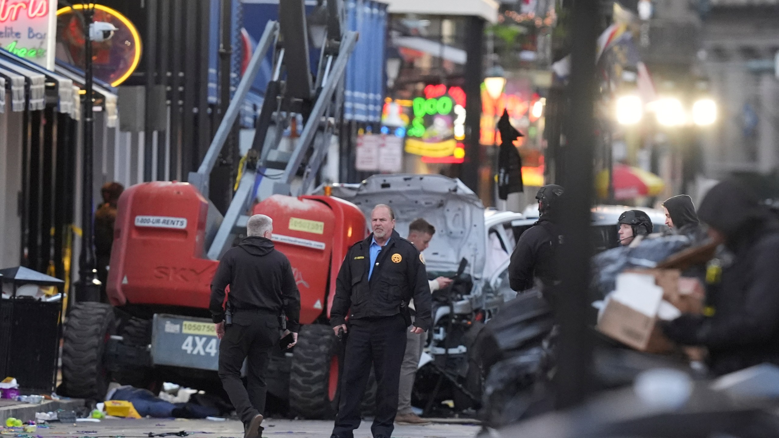 EDS NOTE: GRAPHIC CONTENT - Security personnel investigate the scene on Bourbon Street after a vehicle drove into a crowd on New Orleans' Canal and Bourbon Street, Wednesday Jan. 1, 2025. (AP Photo/Gerald Herbert)