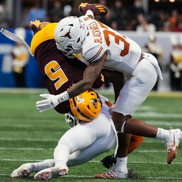 Texas linebacker Morice Blackwell Jr. (37) hits Arizona State wide receiver Melquan Stovall (5) during the first half in the quarterfinals of a College Football Playoff, Wednesday, Jan. 1, 2025, in Atlanta. (AP Photo/Brynn Anderson)