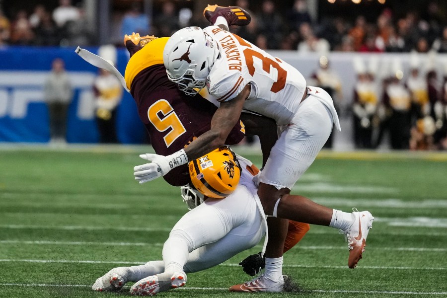 Texas linebacker Morice Blackwell Jr. (37) hits Arizona State wide receiver Melquan Stovall (5) during the first half in the quarterfinals of a College Football Playoff, Wednesday, Jan. 1, 2025, in Atlanta. (AP Photo/Brynn Anderson)