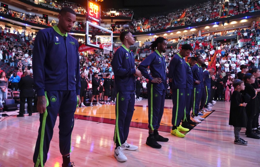 New Orleans Pelicans players stand during a tribute at the Kaseya Center for people killed after a vehicle drove into a crowd in New Orleans before an NBA basketball game between the Miami Heat and the New Orleans Pelicans, Wednesday, Jan. 1, 2025, in Miami. (AP Photo/Lynne Sladky)