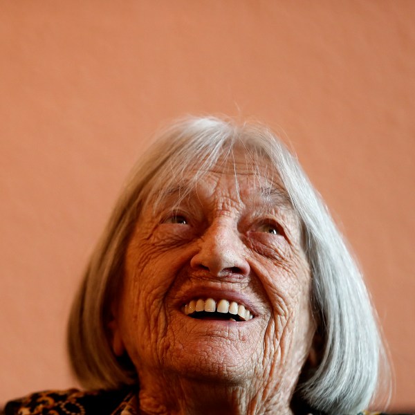 FILE - Agnes Keleti, former Olympic gold medal winning gymnast, smiles at her apartment in Budapest, Hungary Wednesday Jan. 8, 2020. (AP Photo/Laszlo Balogh, File)