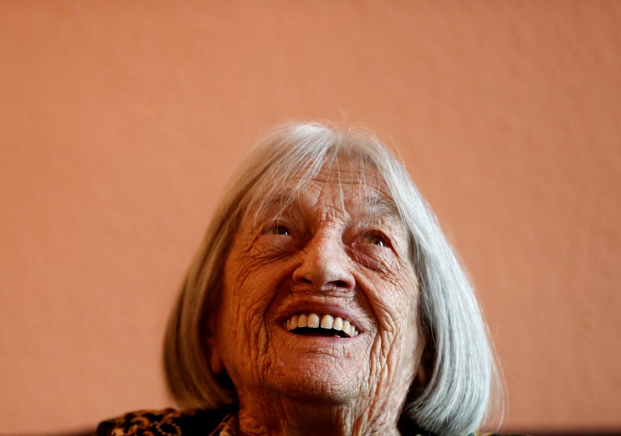 FILE - Agnes Keleti, former Olympic gold medal winning gymnast, smiles at her apartment in Budapest, Hungary Wednesday Jan. 8, 2020. (AP Photo/Laszlo Balogh, File)