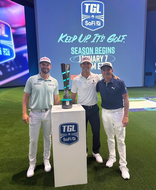 Wyndham Clark, left, Billy Horschel, center, and Rickie Fowler pose with the SoFi Cup on Wednesday, Dec. 18, 2024, in Palm Beach Gardens, Fla. The trophy goes to the winner of six teams competing in the new TMRW Golf League held in a tech-infused indoor arena. It debuts on Jan. 7, 2025 in prime time on ESPN. (AP Photo/Doug Ferguson)