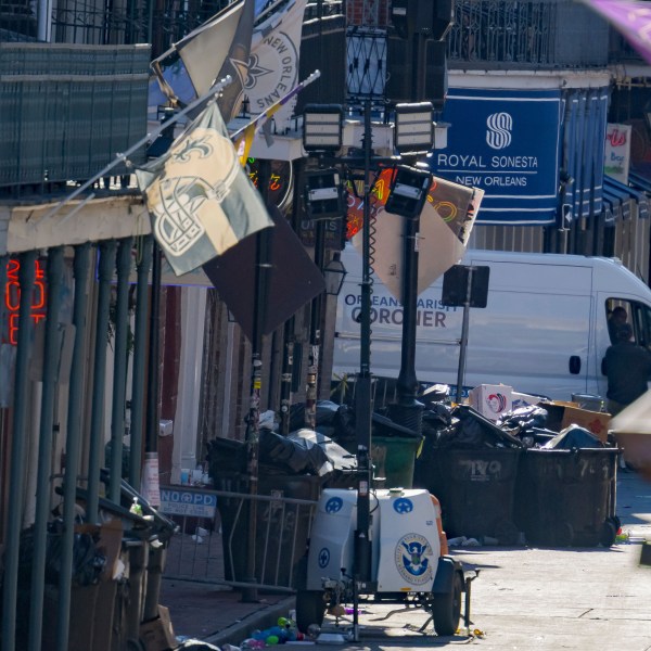 An Orleans Parish Coroner van is seen on Bourbon Street during the investigation of a pickup truck crashing into pedestrians on Bourbon Street in front of the Royal Sonesta Hotel in the French Quarter in New Orleans, Wednesday, Jan. 1, 2025. (AP Photo/Matthew Hinton)