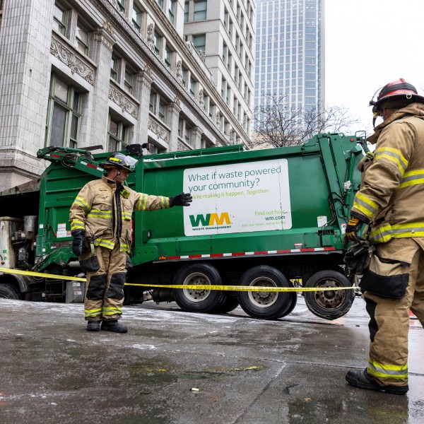 The Omaha Fire Department is on the scene where a garbage truck got stuck in a sinkhole in downtown Omaha, Neb., Thursday, Jan. 2, 2025. (Chris Machian/Omaha World-Herald via AP)