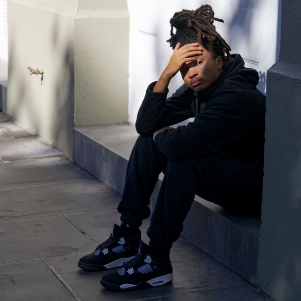 Trevant Hayes, 20, sits in the French Quarter after the death of his friend, Nikyra Dedeaux, 18, after a pickup truck crashed into pedestrians on Bourbon Street followed by a shooting in the French Quarter in New Orleans, Wednesday, Jan. 1, 2025. (AP Photo/Matthew Hinton)