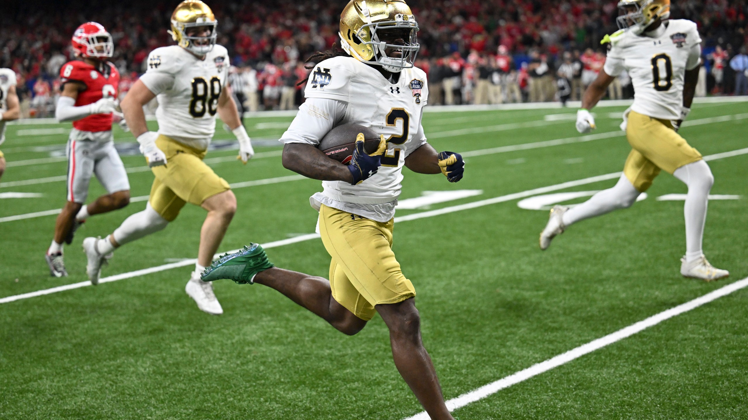 Notre Dame's Jayden Harrison (2) returns a kickoff 98 yards for a touchdown during the second half against Georgia in the quarterfinals of a College Football Playoff, Thursday, Jan. 2, 2025, in New Orleans. (AP Photo/Matthew Hinton)