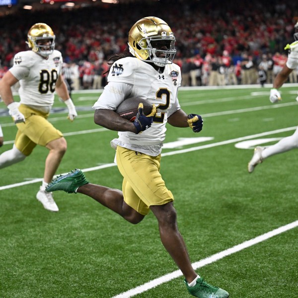 Notre Dame's Jayden Harrison (2) returns a kickoff 98 yards for a touchdown during the second half against Georgia in the quarterfinals of a College Football Playoff, Thursday, Jan. 2, 2025, in New Orleans. (AP Photo/Matthew Hinton)