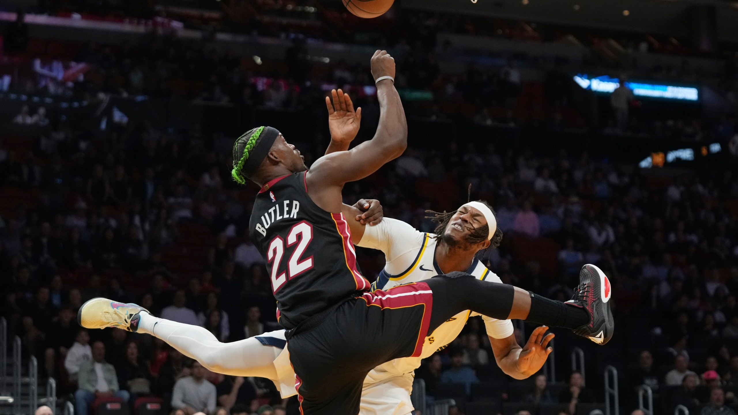 Miami Heat forward Jimmy Butler (22) goes to the basket as Indiana Pacers center Myles Turner, right, defends during the first half of an NBA basketball game Thursday, Jan. 2, 2025, in Miami. (AP Photo/Lynne Sladky)