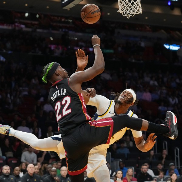 Miami Heat forward Jimmy Butler (22) goes to the basket as Indiana Pacers center Myles Turner, right, defends during the first half of an NBA basketball game Thursday, Jan. 2, 2025, in Miami. (AP Photo/Lynne Sladky)