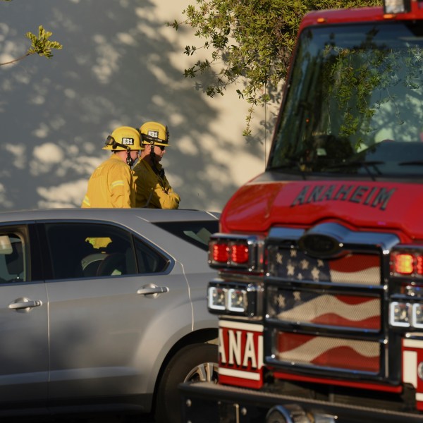 Firefighter stage outside a building where a plane crash occurred Thursday, Jan. 2, 2025, in Fullerton, Calif. (AP Photo/Kyusung Gong)