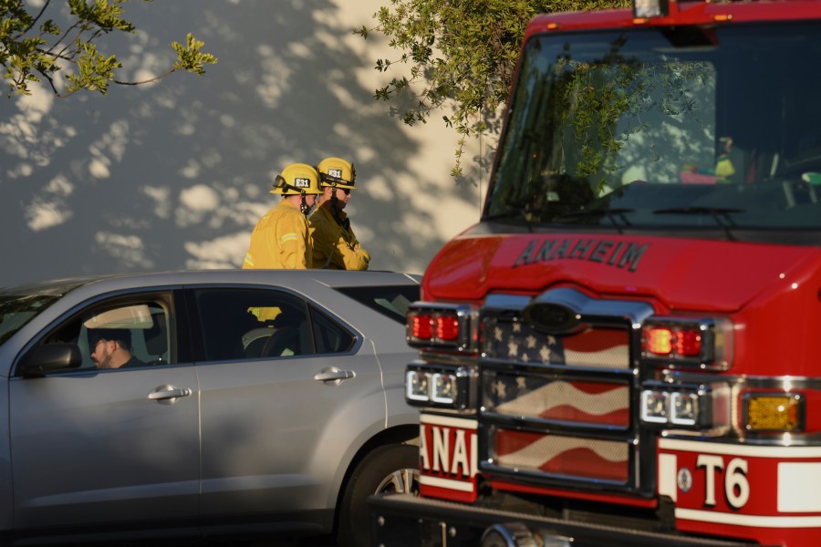 Firefighter stage outside a building where a plane crash occurred Thursday, Jan. 2, 2025, in Fullerton, Calif. (AP Photo/Kyusung Gong)