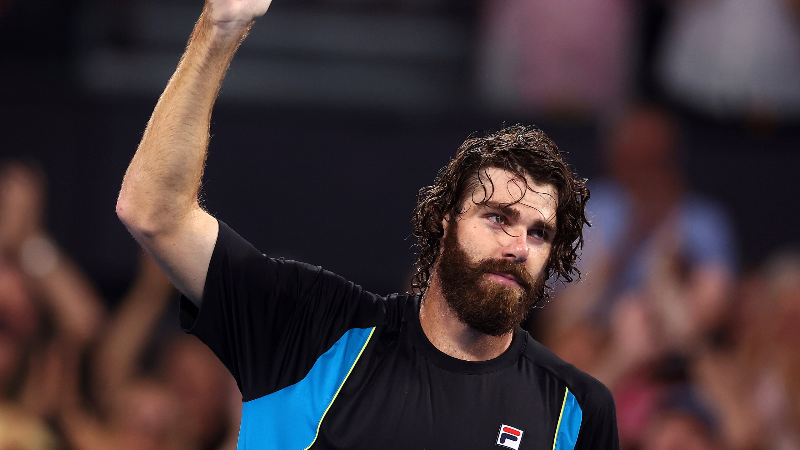 USA's Reilly Opelka celebrates winning his match against Serbia's Novak Djokovic at the Brisbane International, in Brisbane, Australia, Friday, Jan. 3, 2025. (AP Photo/Pat Hoelscher)