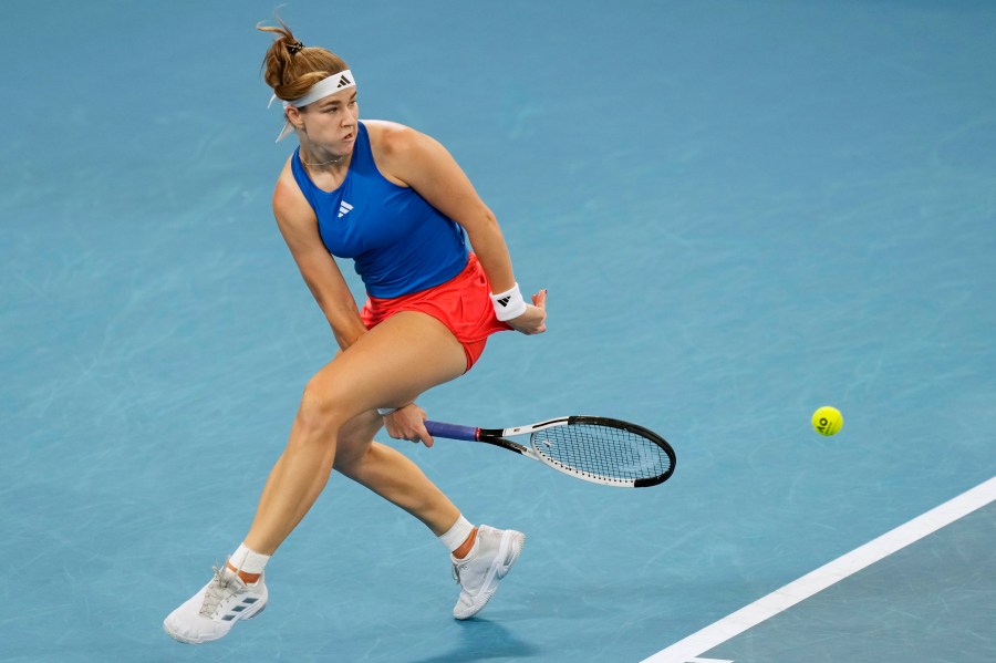 Czechia's Karolina Muchova plays a shot between her legs to Italy's Jasmine Paolini during their quarterfinal match at the United Cup tennis tournament in Sydney, Australia, Friday, Jan. 3, 2025. (AP Photo/Rick Rycroft)