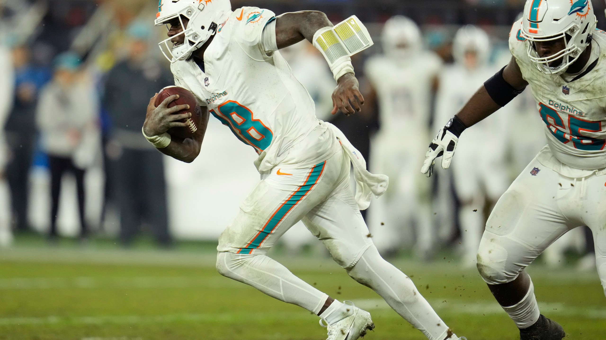 Miami Dolphins quarterback Tyler Huntley (18) runs during the second half of an NFL football game against the Cleveland Browns Sunday, Dec. 29, 2024, in Cleveland. (AP Photo/Sue Ogrocki)