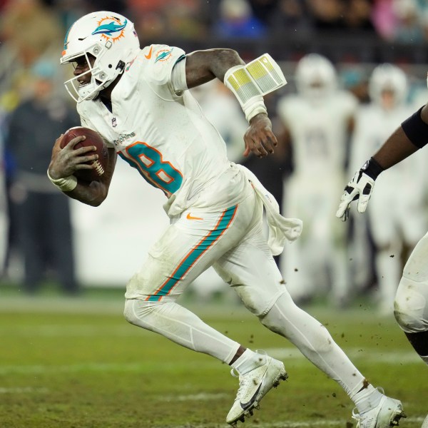 Miami Dolphins quarterback Tyler Huntley (18) runs during the second half of an NFL football game against the Cleveland Browns Sunday, Dec. 29, 2024, in Cleveland. (AP Photo/Sue Ogrocki)