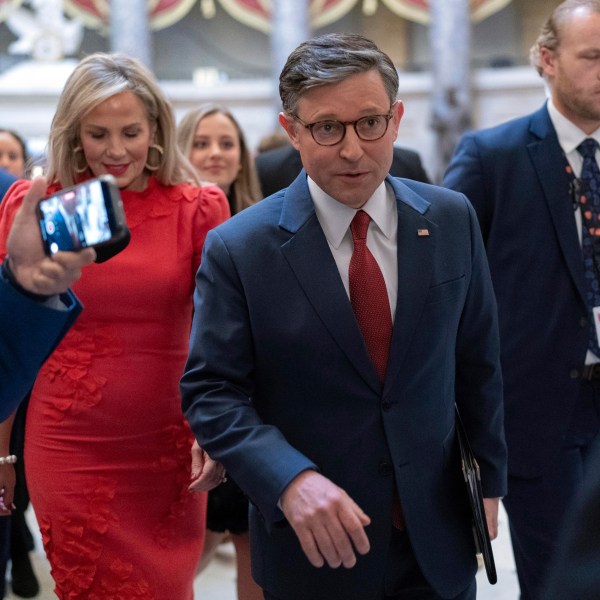 Speaker of the House Mike Johnson, R-La., accompanied by his wife Kelly Johnson, left, walks to the House Chamber before starting the 119th United States Congress at the Capitol in Washington, Friday, Jan. 3, 2025. (AP Photo/Jose Luis Magana)