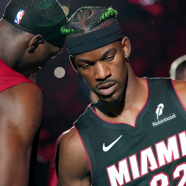 Miami Heat forward Jimmy Butler (22) and center Bam Adebayo, left, are introduced before an NBA basketball game against the Indiana Pacers Thursday, Jan. 2, 2025, in Miami. (AP Photo/Lynne Sladky)