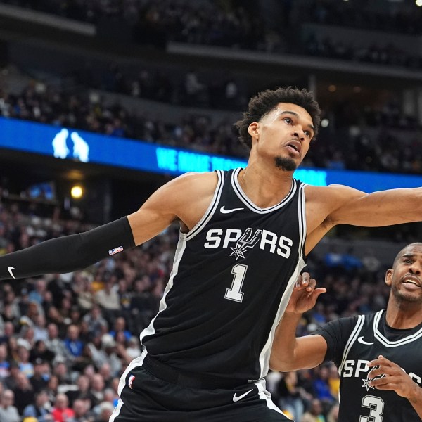 San Antonio Spurs center Victor Wembanyama pursues a rebound in the first half of an NBA basketball game against the Denver Nuggets Friday, Jan. 3, 2025, in Denver. (AP Photo/David Zalubowski)