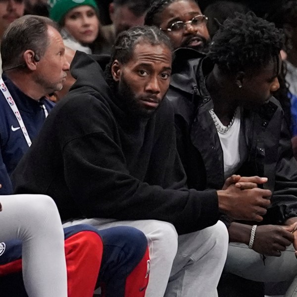 Los Angeles Clippers forward Kawhi Leonard watches from the bench during the first quarter of an NBA basketball game against the Dallas Mavericks, Saturday, Dec. 21, 2024, in Dallas. (AP Photo/LM Otero)