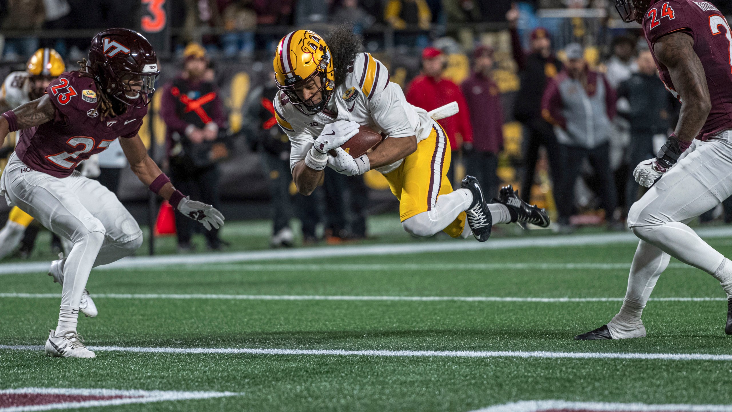 Minnesota wide receiver Elijah Spencer (11) dives in for a touchdown during the first half of the Duke's Mayo Bowl NCAA college football game Friday, Jan. 3, 2025, in Charlotte, N.C.(AP Photo/Robert Simmons)