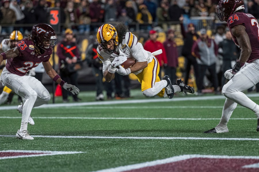 Minnesota wide receiver Elijah Spencer (11) dives in for a touchdown during the first half of the Duke's Mayo Bowl NCAA college football game Friday, Jan. 3, 2025, in Charlotte, N.C.(AP Photo/Robert Simmons)