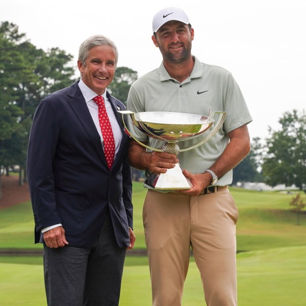 FILE - PGA Tour Commissioner Jay Monahan, left, poses with Scottie Scheffler and the FedExCup Trophy after Scheffler won the final round of the Tour Championship golf tournament, Sunday, Sept. 1, 2024, in Atlanta. (AP Photo/Jason Allen, File)