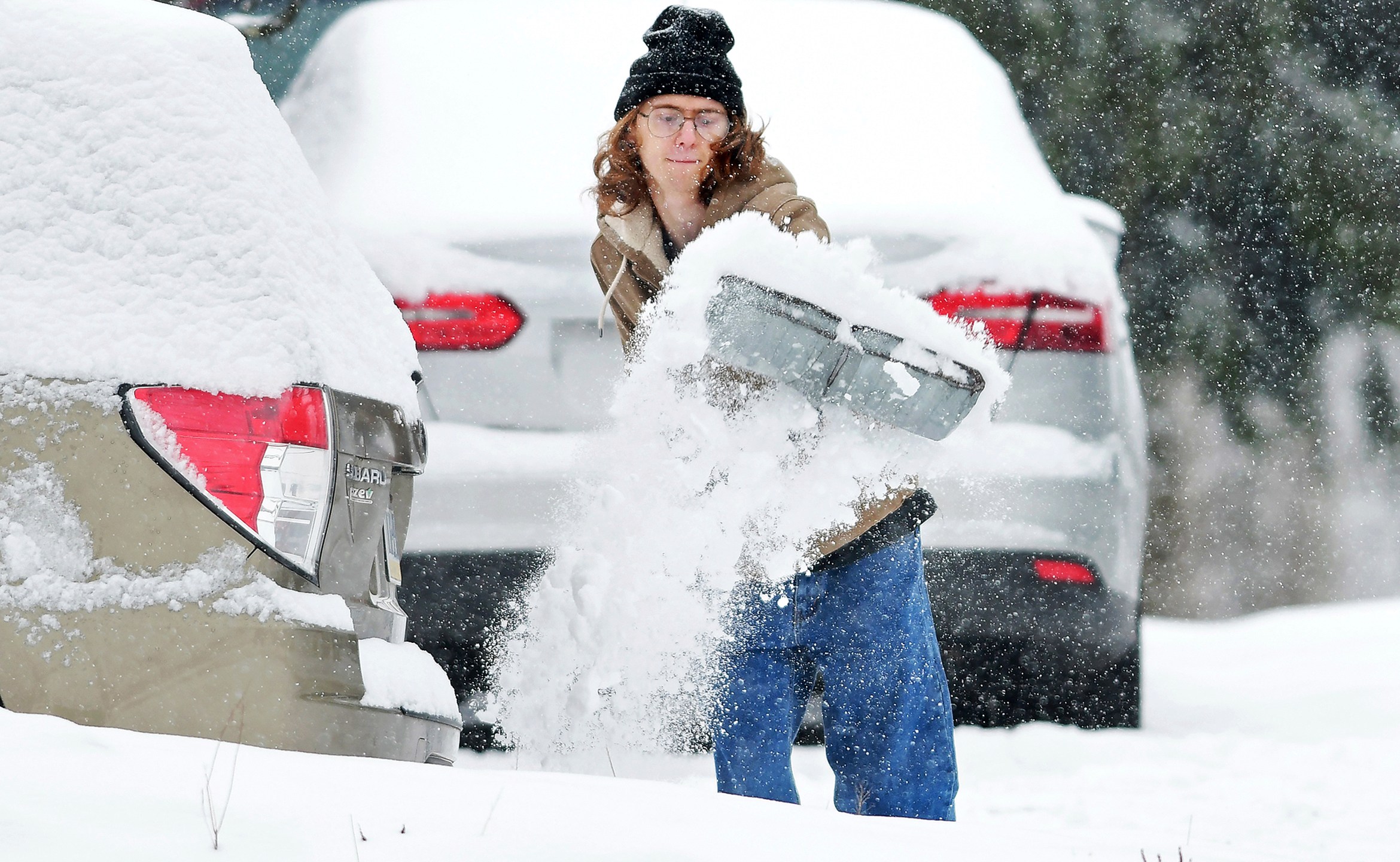 Elijah Minahan, of Johnstown, Pa., shovels out the driveway at his home in Westmont Borough as cold temperatures and snowfall hits the region on Friday, January 3, 2025. (Thomas Slusser/The Tribune-Democrat via AP)