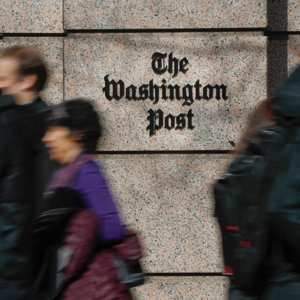 FILE - People walk by the One Franklin Square Building, home of The Washington Post newspaper, in downtown Washington, Feb. 21, 2019. (AP Photo/Pablo Martinez Monsivais, File)