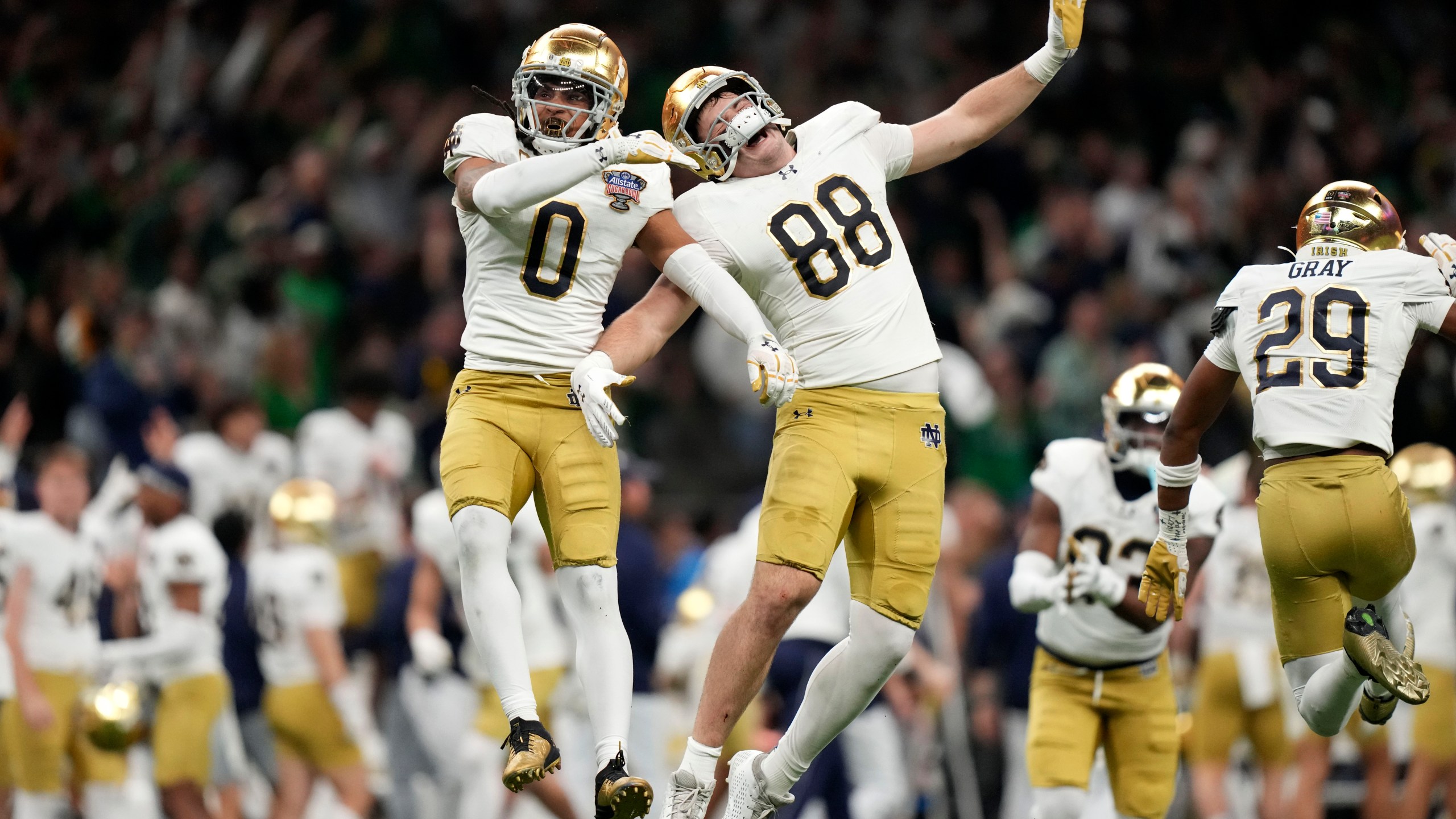 Notre Dame safety Xavier Watts (0) celebrates with teammate Armel Mukam (88) during the second half against Georgia in the quarterfinals of a College Football Playoff, Thursday, Jan. 2, 2025, in New Orleans. (AP Photo/Gerald Herbert)