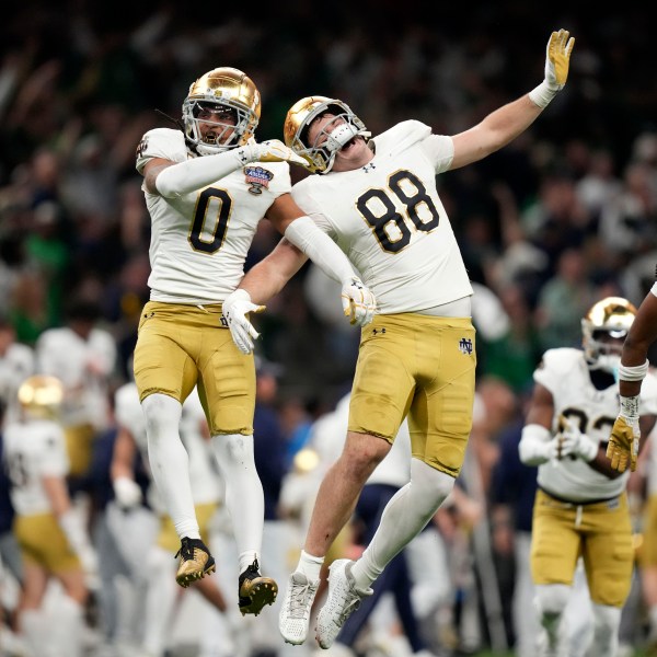 Notre Dame safety Xavier Watts (0) celebrates with teammate Armel Mukam (88) during the second half against Georgia in the quarterfinals of a College Football Playoff, Thursday, Jan. 2, 2025, in New Orleans. (AP Photo/Gerald Herbert)