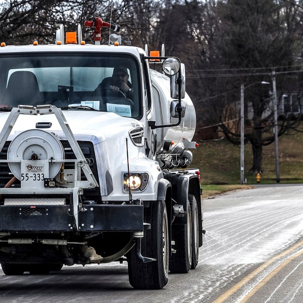 FILE - Steve Beckett with the street department in Owensboro, Ky., sprays a salt brine solution along Hickman Avenue in preparation for predicted snow and ice over the weekend, Friday, Jan. 3, 2025, in Owensboro, Ky. (Greg Eans/The Messenger-Inquirer via AP, File)