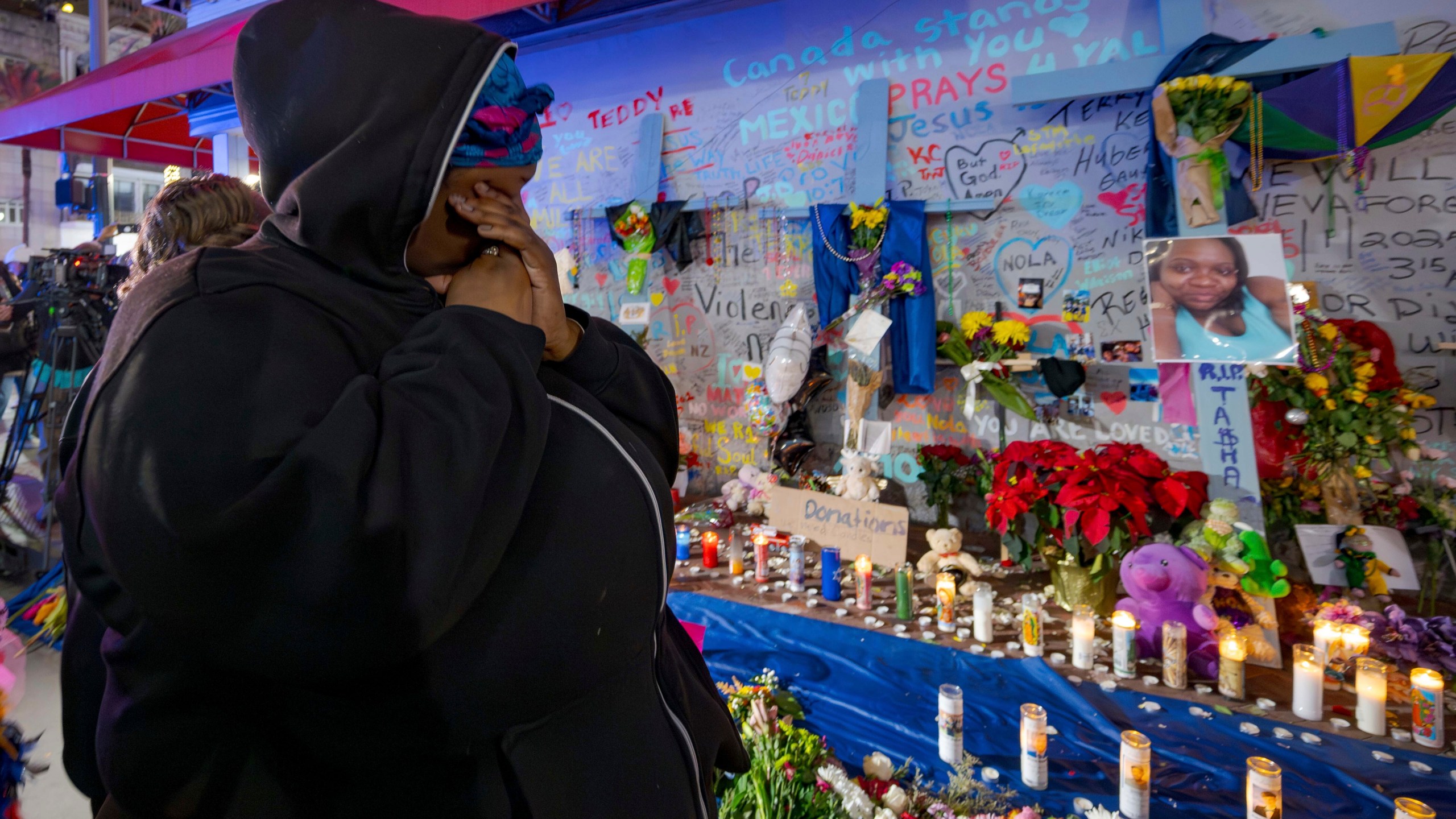 Courtney Polk, cousin of Tasha Polk, who was killed in the New Year's Day attack, reacts at a memorial on Bourbon Street and Canal Street in New Orleans, Saturday, Jan. 4, 2025, (AP Photo/Matthew Hinton)