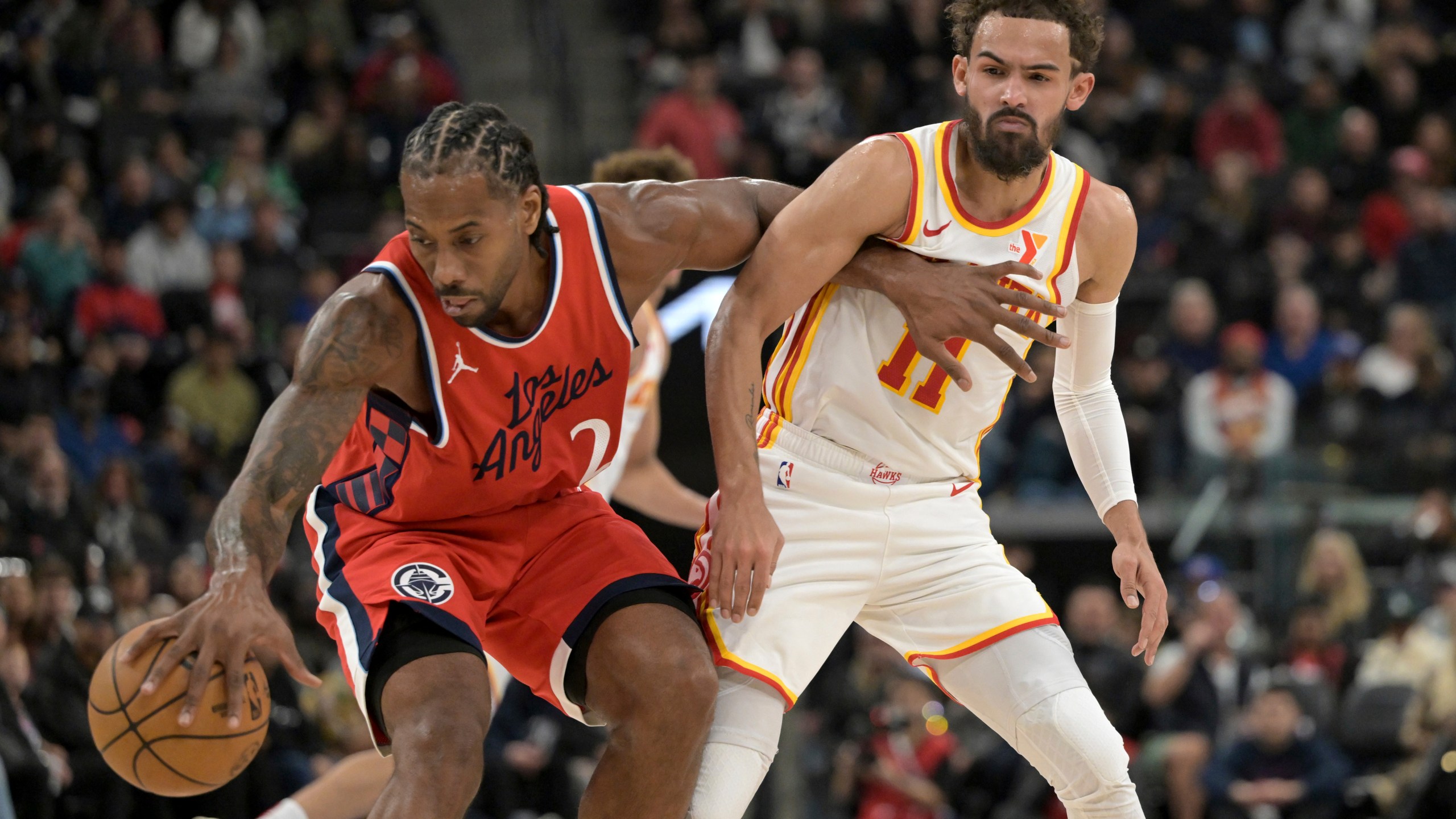 Los Angeles Clippers forward Kawhi Leonard, left, steals the ball from Atlanta Hawks guard Trae Young during the first half of an NBA basketball game Saturday, Jan. 4, 2025, in Los Angeles. (AP Photo/Jayne-Kamin-Oncea)