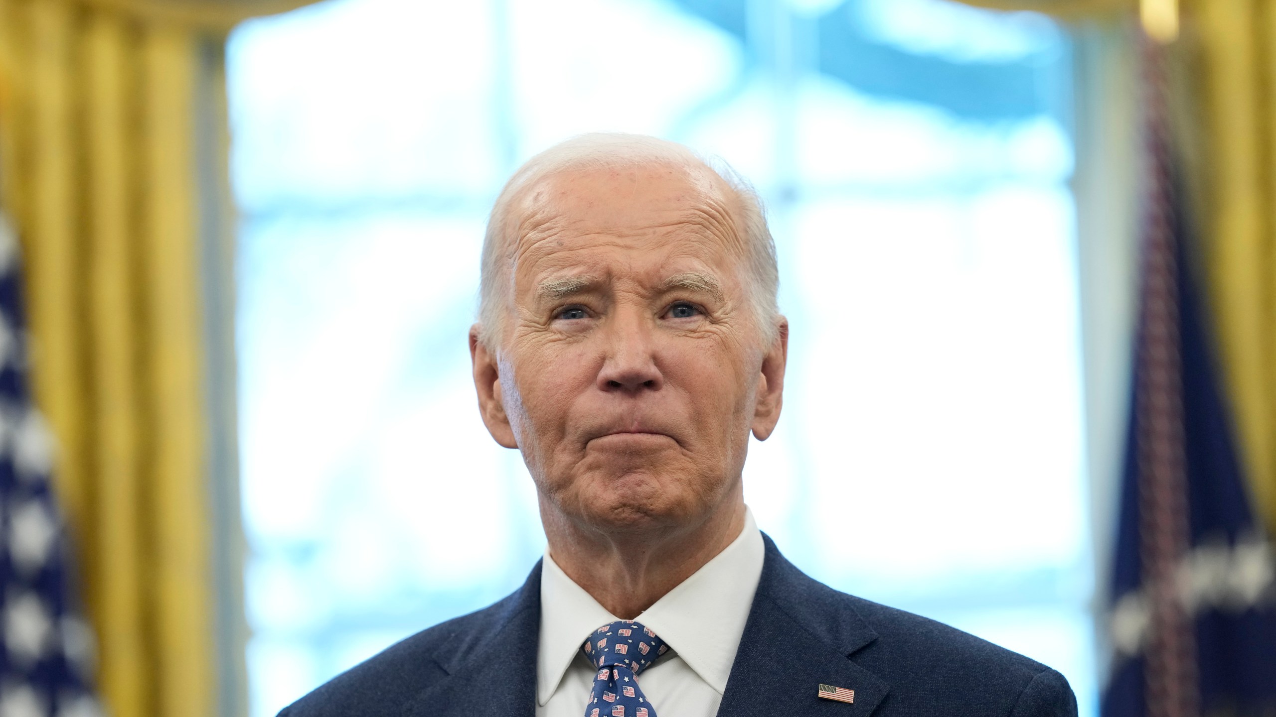 President Joe Biden pauses during a photo opportunity with Medal of Valor recipients in the Oval Office of the White House in Washington, Friday, Jan. 3, 2025. (AP Photo/Susan Walsh)