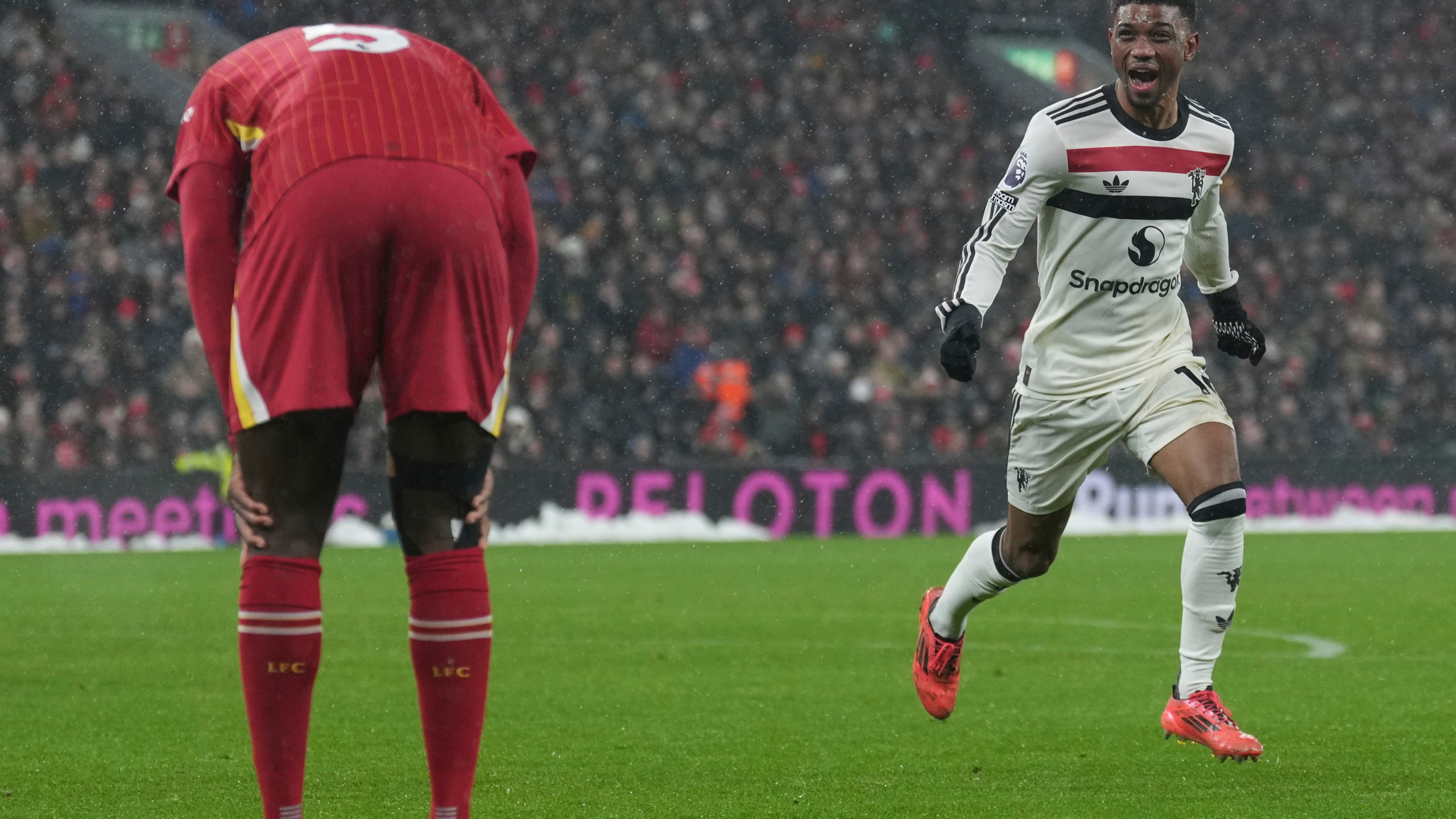 Manchester United's Amad Diallo celebrates after scoring his side's second goal against Liverpool during the English Premier League soccer match at the Anfield stadium in Liverpool, England, Sunday, Jan. 5, 2025. (AP Photo/Jon Super)