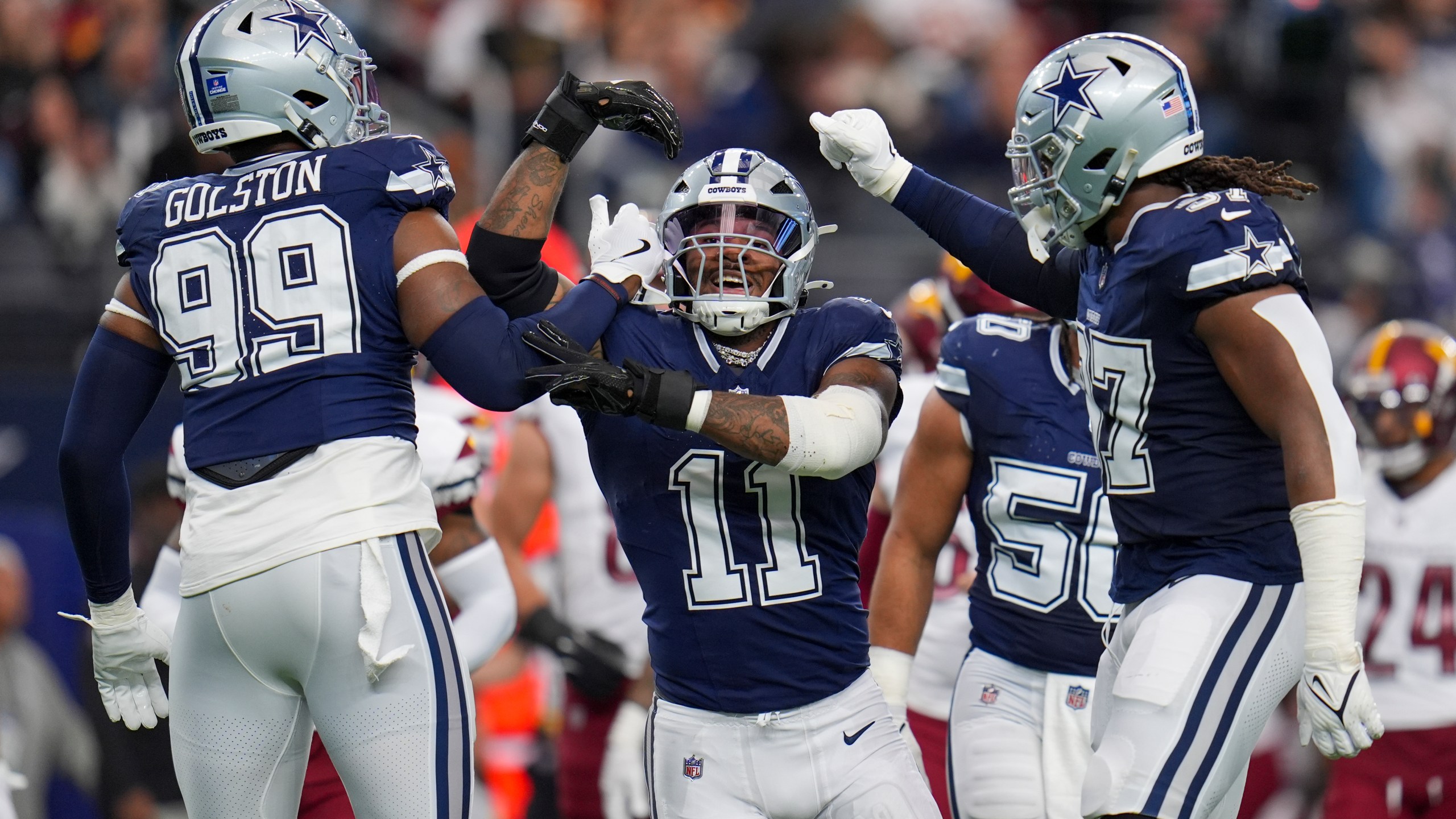 Dallas Cowboys linebacker Micah Parsons (11) celebrates a sack with defensive end Chauncey Golston (99) and linebacker Buddy Johnson (57) during the first half of an NFL football game against the Washington Commanders, Sunday, Jan. 5, 2025, in Arlington, Texas. (AP Photo/Josh McSwain)