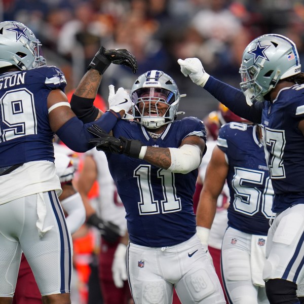 Dallas Cowboys linebacker Micah Parsons (11) celebrates a sack with defensive end Chauncey Golston (99) and linebacker Buddy Johnson (57) during the first half of an NFL football game against the Washington Commanders, Sunday, Jan. 5, 2025, in Arlington, Texas. (AP Photo/Josh McSwain)