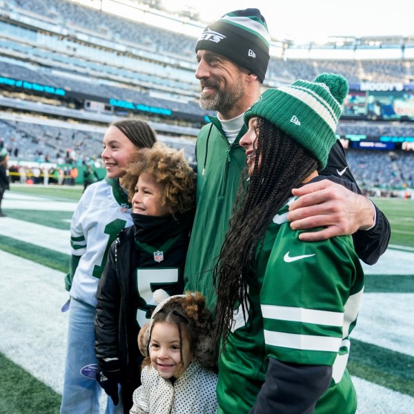 New York Jets quarterback Aaron Rodgers poses with fans before an NFL football game against the Miami Dolphins, Sunday, Jan. 5, 2024, in East Rutherford, N.J. (AP Photo/Seth Wenig)