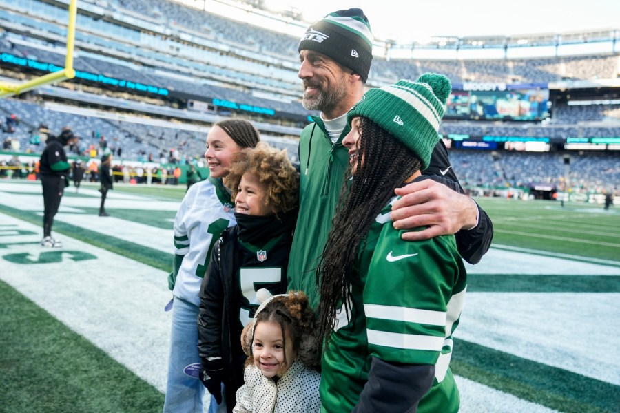 New York Jets quarterback Aaron Rodgers poses with fans before an NFL football game against the Miami Dolphins, Sunday, Jan. 5, 2024, in East Rutherford, N.J. (AP Photo/Seth Wenig)