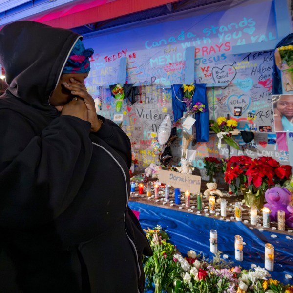 CORRECTS NAME TO LATASHA NOT TASHA Courtney Polk, cousin of LaTasha Polk, who was killed in the New Year's Day attack, reacts at a memorial on Bourbon Street and Canal Street in New Orleans, Saturday, Jan. 4, 2025, (AP Photo/Matthew Hinton)