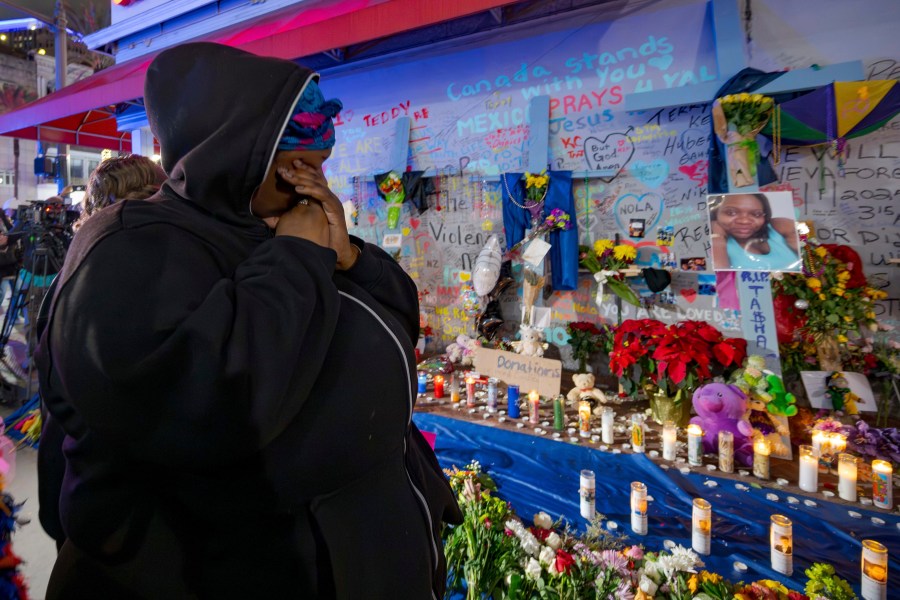 CORRECTS NAME TO LATASHA NOT TASHA Courtney Polk, cousin of LaTasha Polk, who was killed in the New Year's Day attack, reacts at a memorial on Bourbon Street and Canal Street in New Orleans, Saturday, Jan. 4, 2025, (AP Photo/Matthew Hinton)