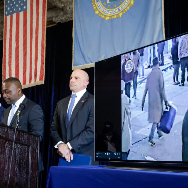 Lyonel Myrthil, special agent in charge of the New Orleans field office, second from left, shows footage of Shamsud-Din Jabbar, the man who carried out an attack on New Orleans' Bourbon Street on New Year's Day, during a news conference in a secure garage at the FBI Headquarters in New Orleans, Sunday, Jan. 5, 2025. (Scott Threlkeld/The Times-Picayune/The New Orleans Advocate via AP)