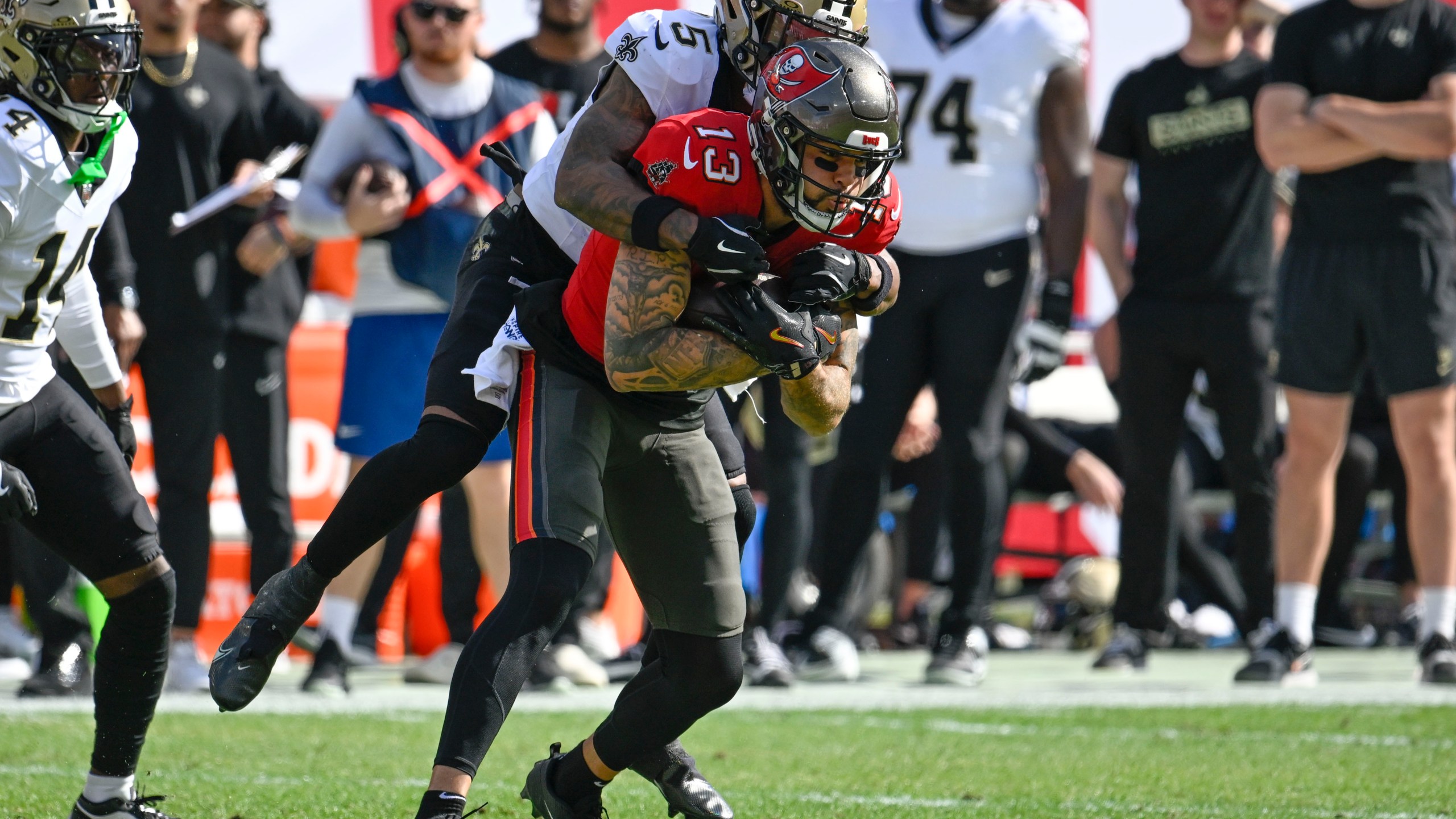 Tampa Bay Buccaneers wide receiver Mike Evans (13) pulls in a pass against New Orleans Saints cornerback Will Harris (5) during the first half of an NFL football game Sunday, Jan. 5, 2025, in Tampa, Fla. (AP Photo/Jason Behnken)