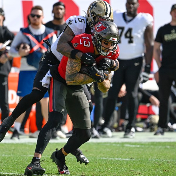 Tampa Bay Buccaneers wide receiver Mike Evans (13) pulls in a pass against New Orleans Saints cornerback Will Harris (5) during the first half of an NFL football game Sunday, Jan. 5, 2025, in Tampa, Fla. (AP Photo/Jason Behnken)