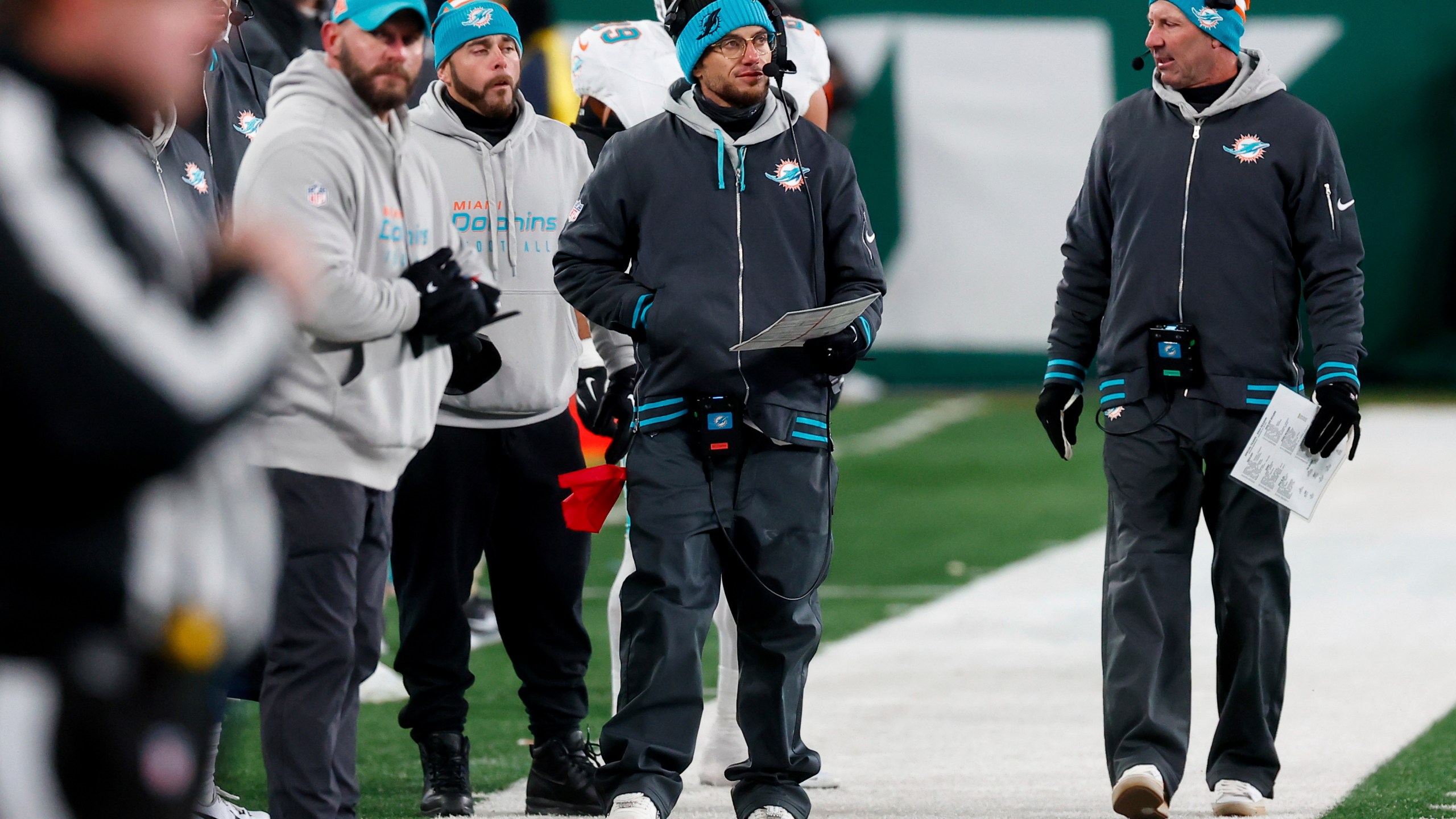 Miami Dolphins head coach Mike McDaniels, center, walks on the sideline during the second half of an NFL football game against the New York Jets, Sunday, Jan. 5, 2025, in East Rutherford, N.J. (AP Photo/Noah K. Murray)