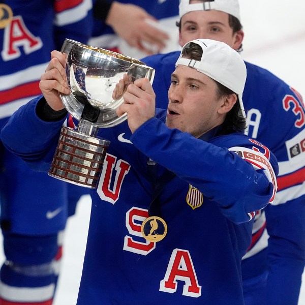 United States forward Ryan Leonard (9) hoists the trophy following their IIHF World Junior Hockey Championship gold medal game win over Finland in Ottawa, Ontario, Sunday, Jan. 5, 2025. (Adrian Wyld/The Canadian Press via AP)